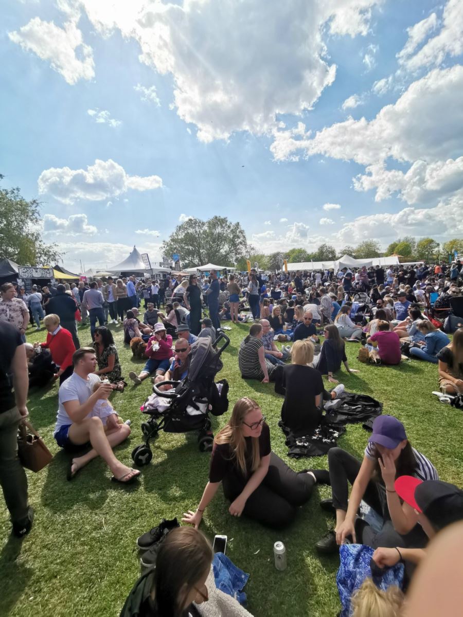 A view over a predominantly seated crowd on a sunny day at the popular Christchurch food festival.